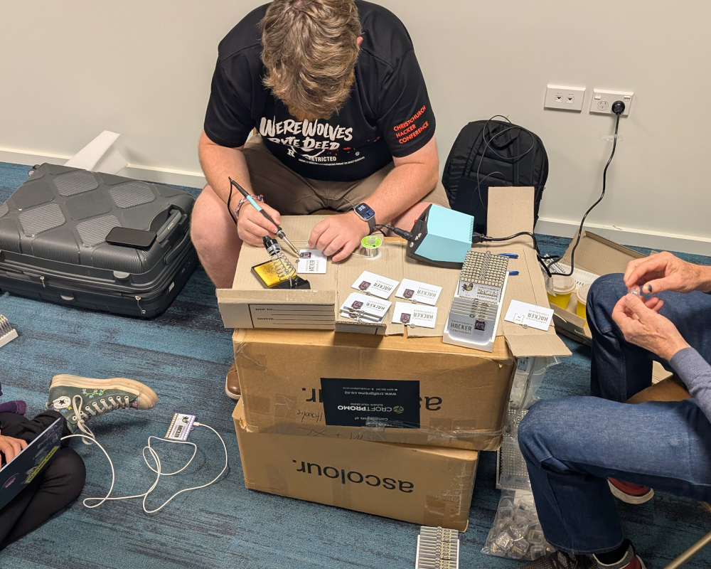 A person using a soldering station to solder ESP32s onto circuit boards